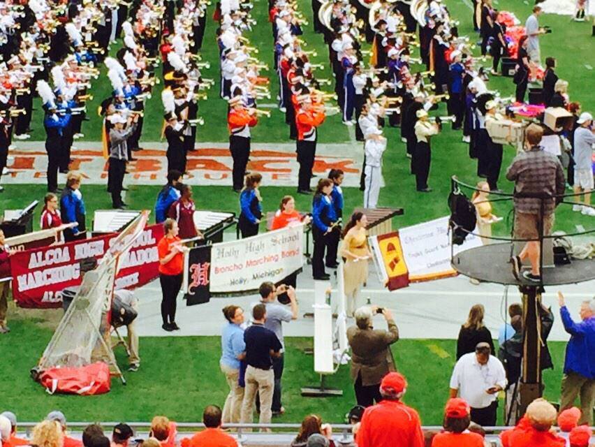 Band members at the Outback Bowl holding sign for Holly Band
