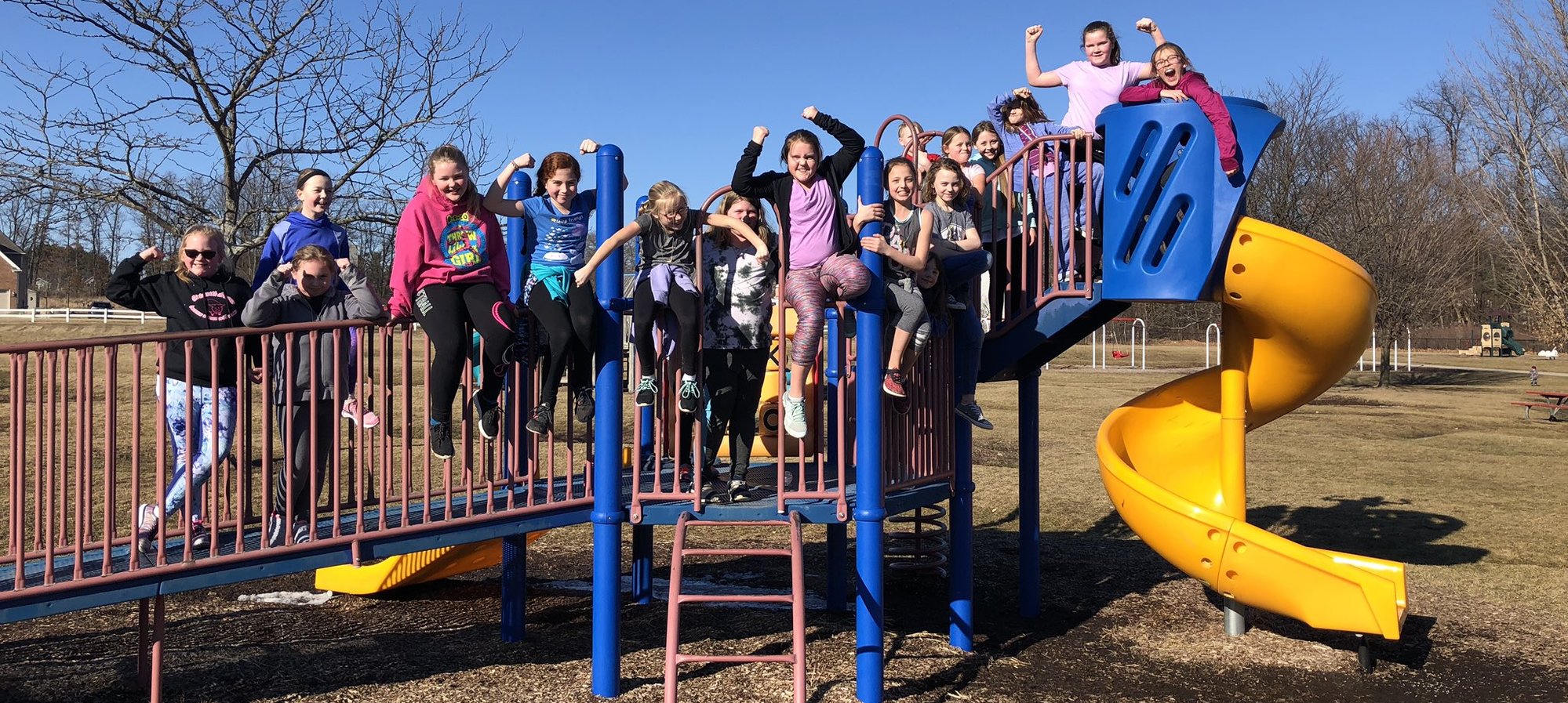 Patterson Girls Running Club posing on the play structure