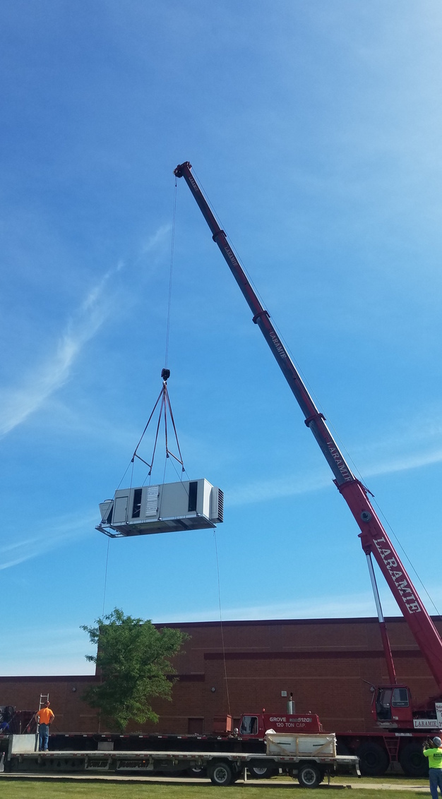 Hoisting a new equipment unit for the pool area