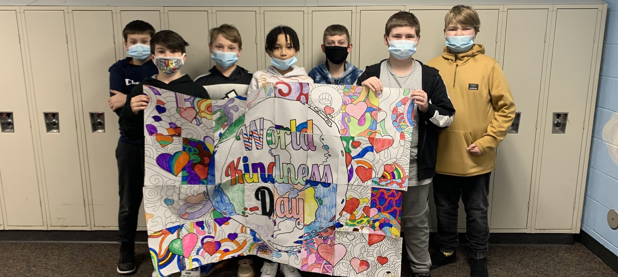 Students with a World Kindness Day banner