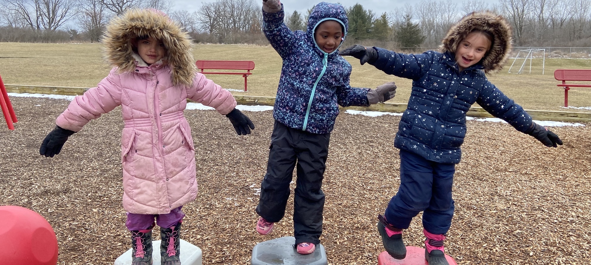 Three students playing outside