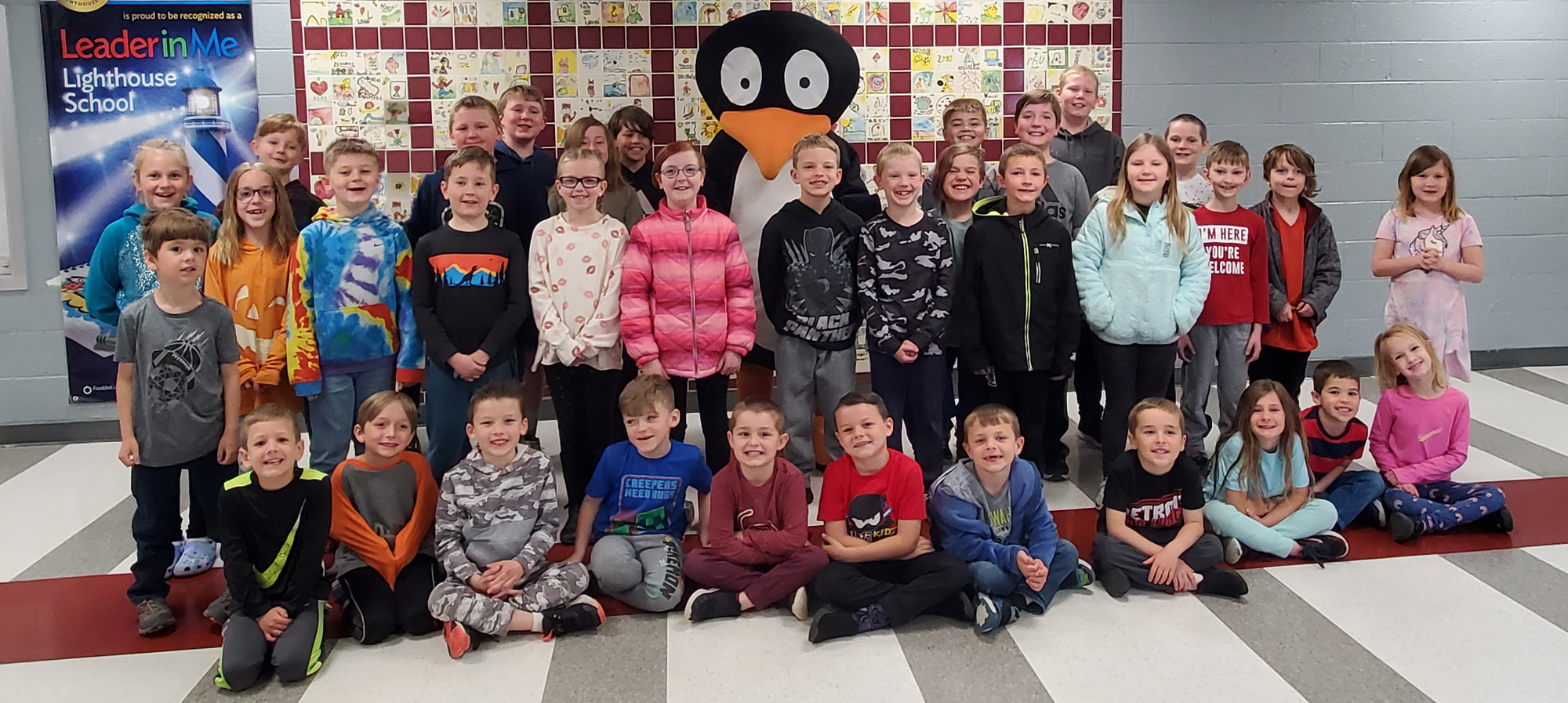 Students with JiJi the Penquin