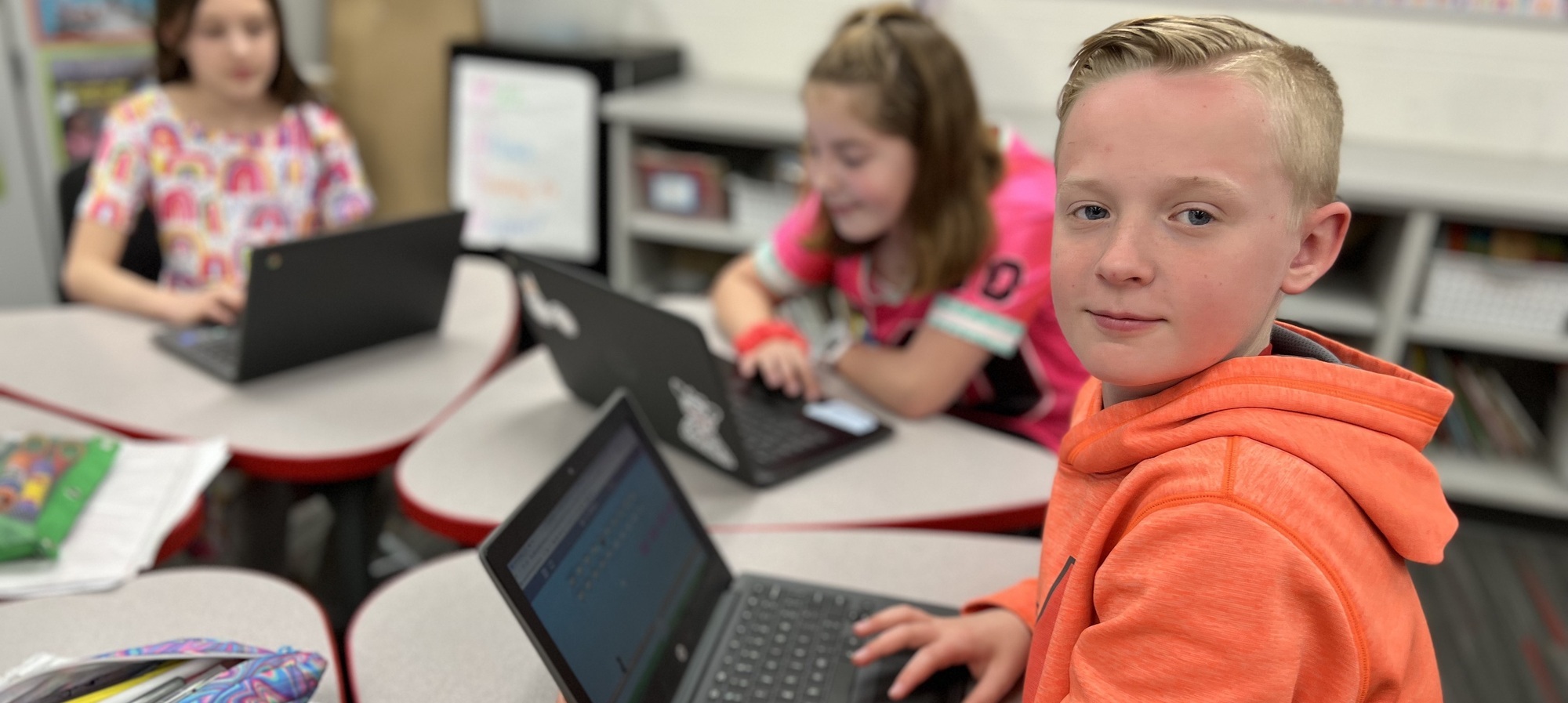 Students in classroom using chromebooks