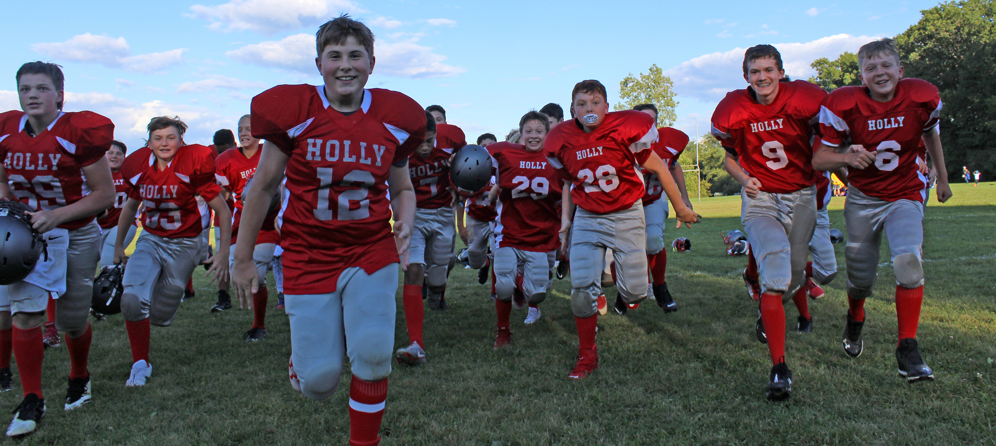 Middle school football players coming on to the field