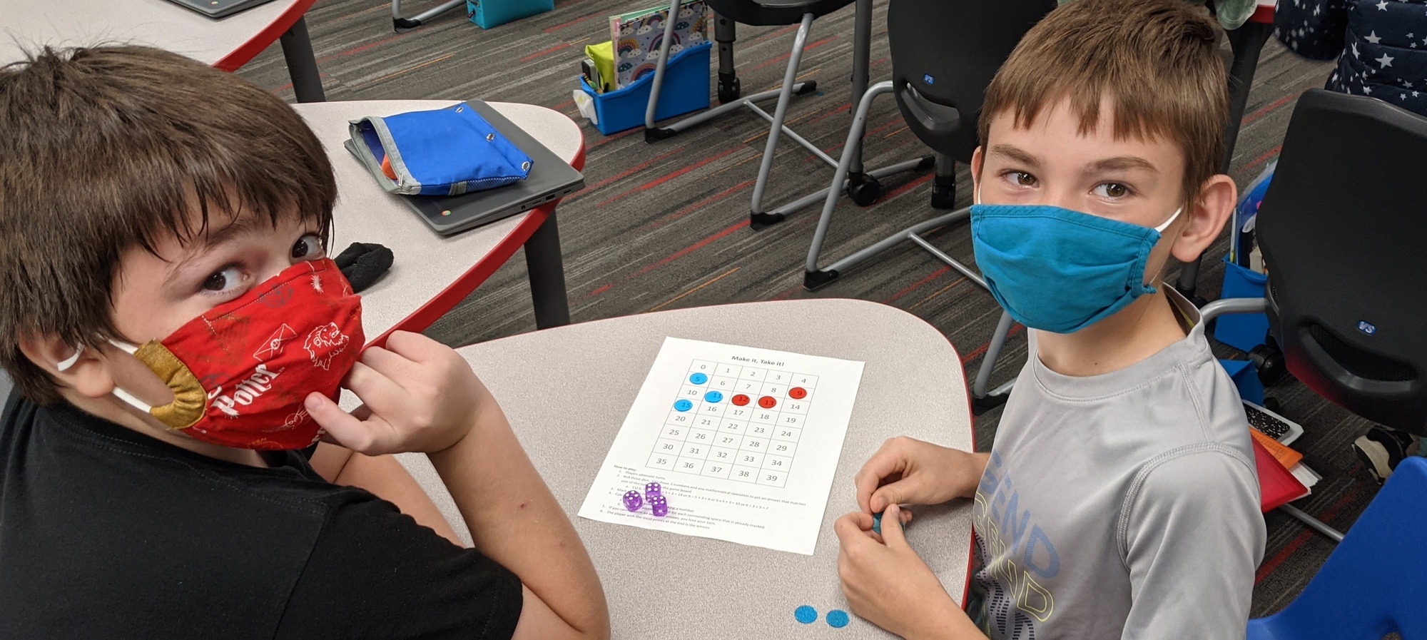 Students working on a dice game for counting