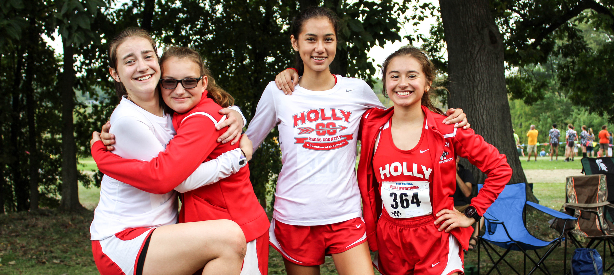 Four girls from the cross-country team posing for a picture.