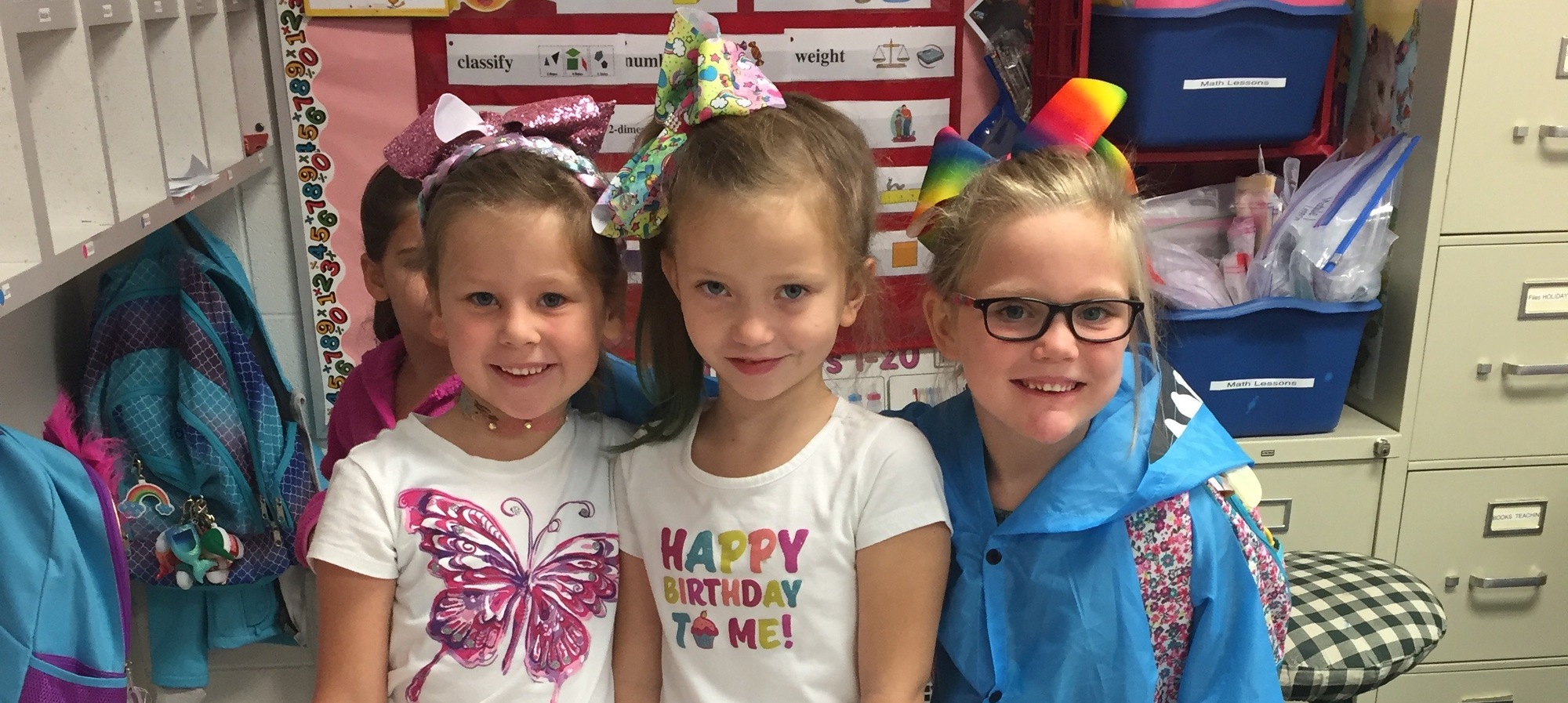 Three girls with bows in their hair.