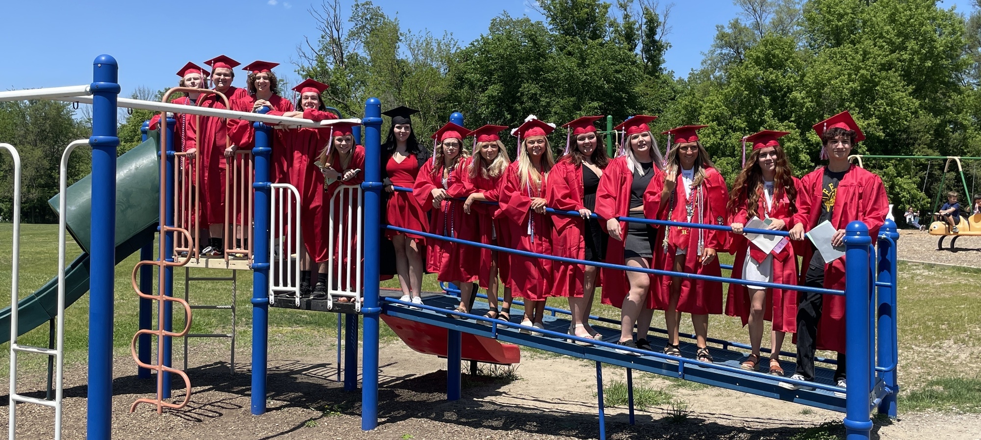 Group of Graduating Senior former Holly El students together on the playground equipment