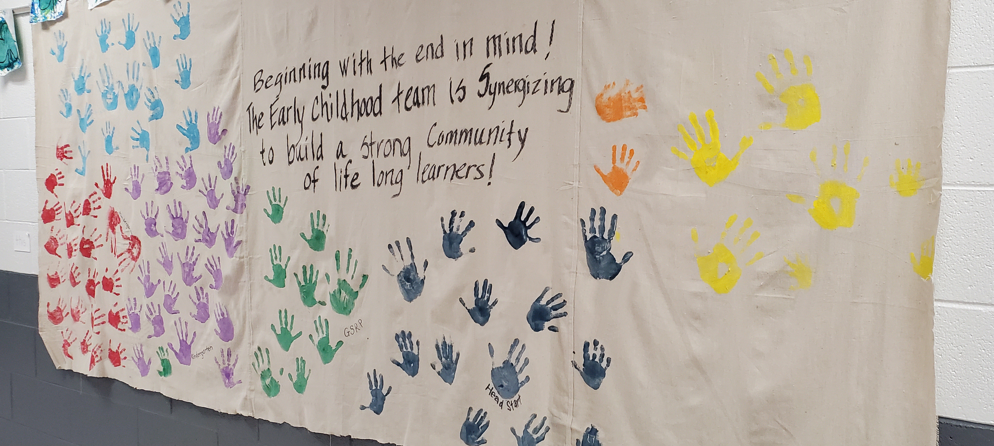 Sign with handprints with message"Beginning with the end in mind..."