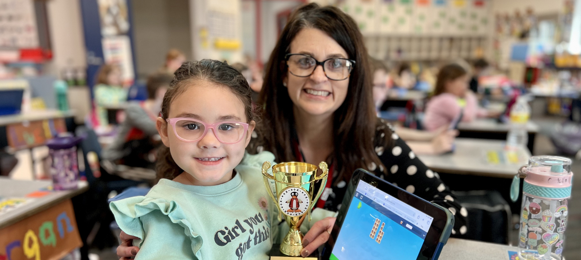 Mrs. Brown with a student using STMath and her award