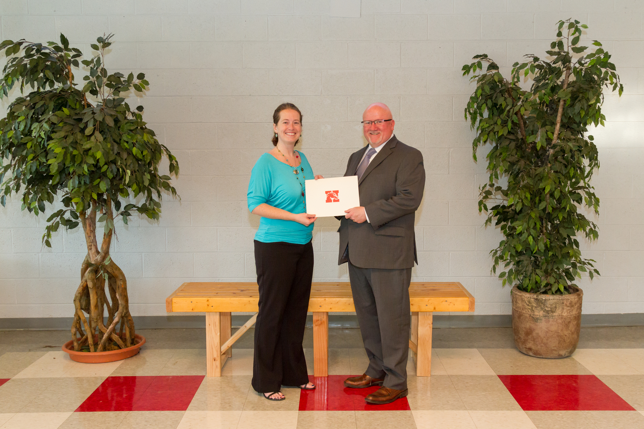 Ms. Jensen and the Board President holding award