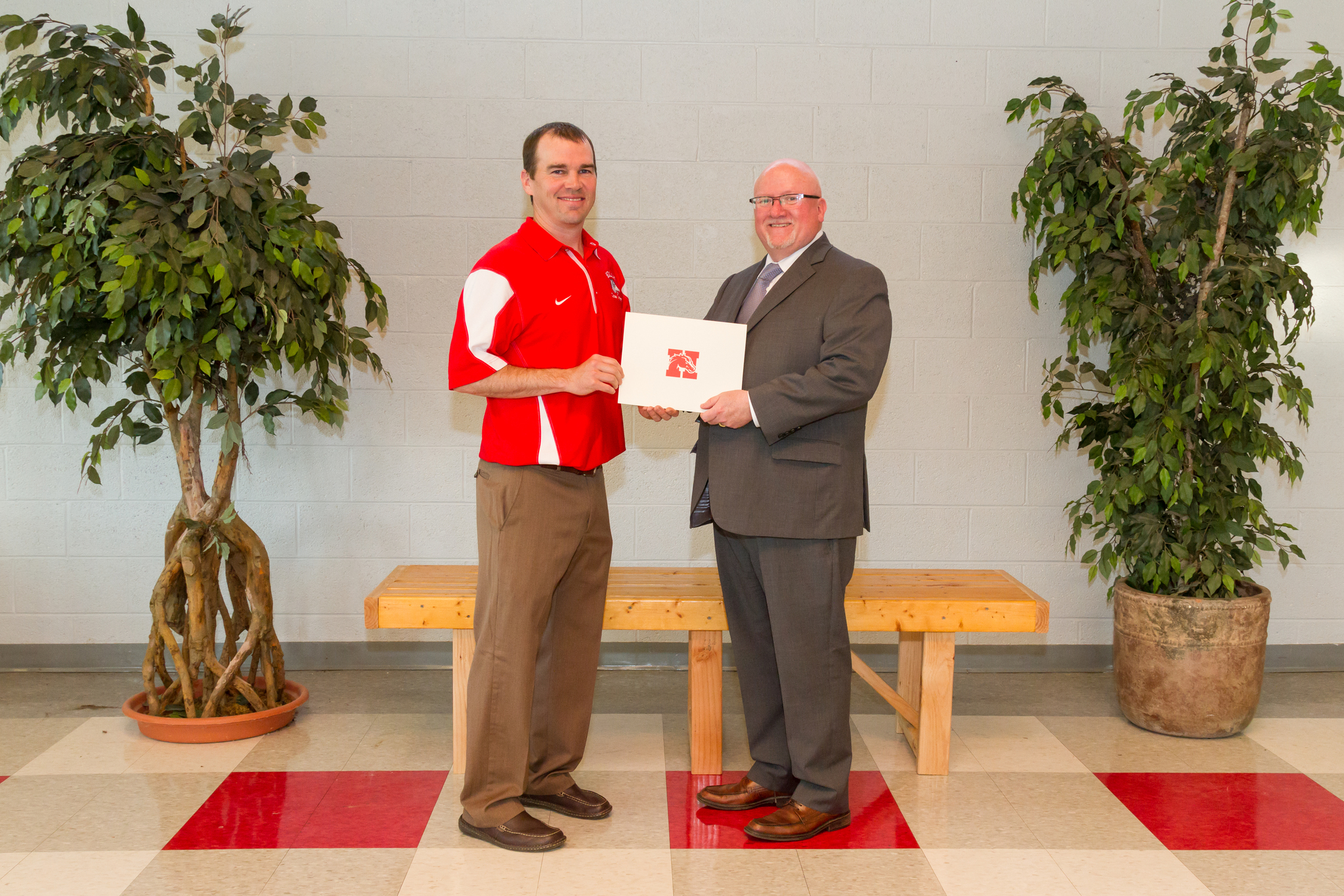 Mr. Brinker and the Board President holding award