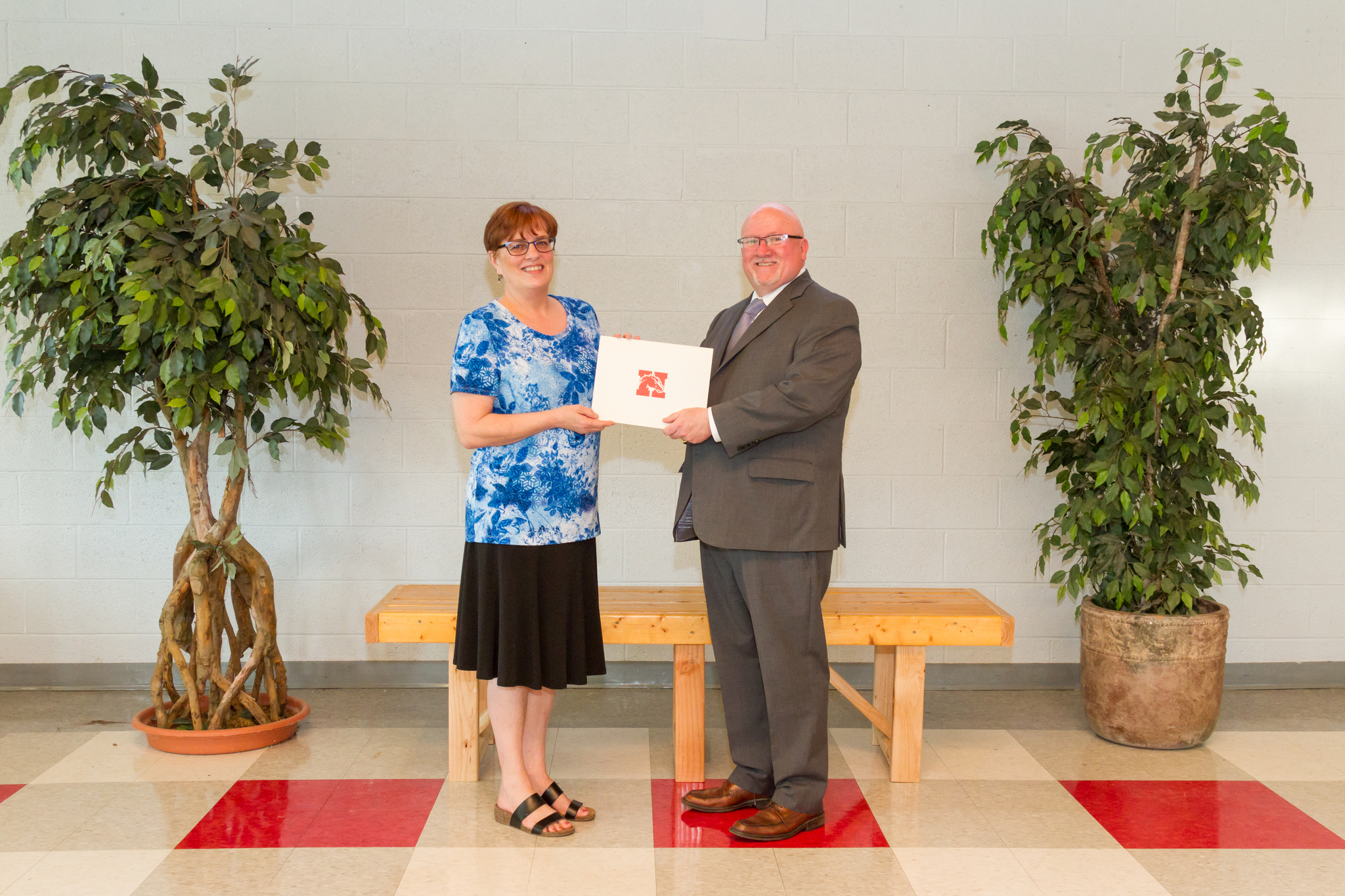 Mrs. Oldaugh and the Board President holding award