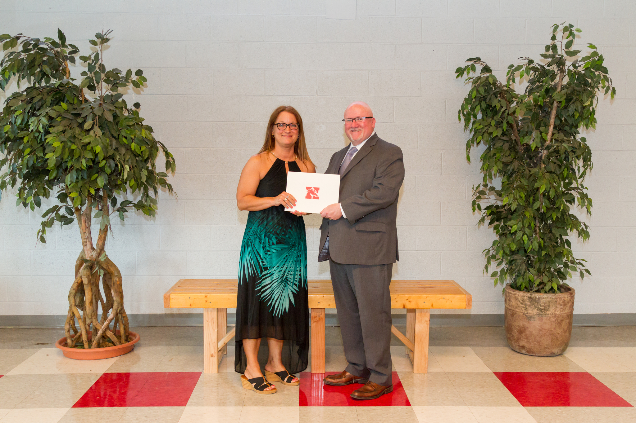 Ms. Robb and the Board President holding award