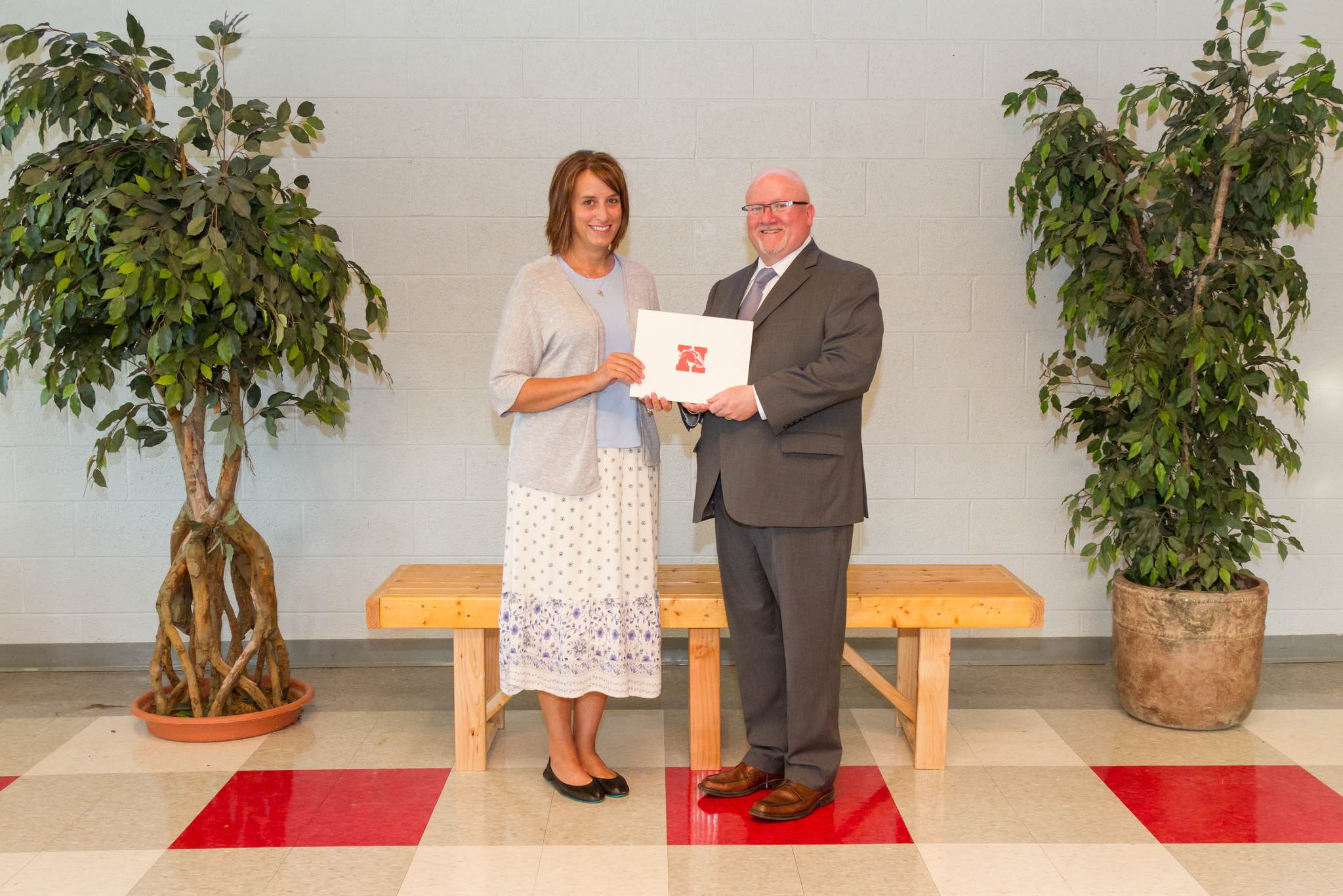 Mrs. McDowell and the Board President holding award