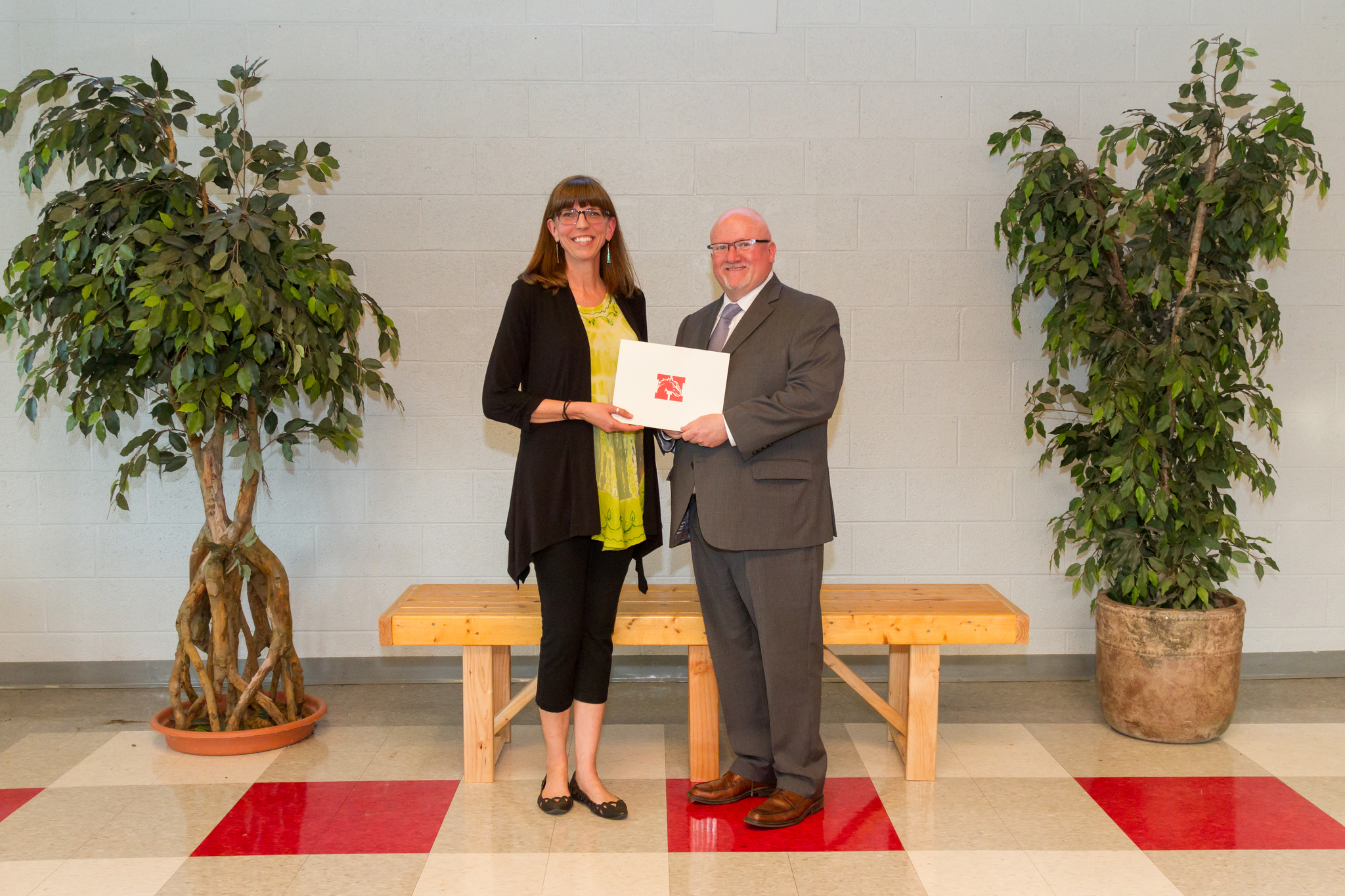 Mrs. Courtney and the Board President holding award