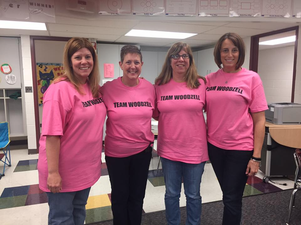Teachers at PEL in their Team Woodzell pink shirts