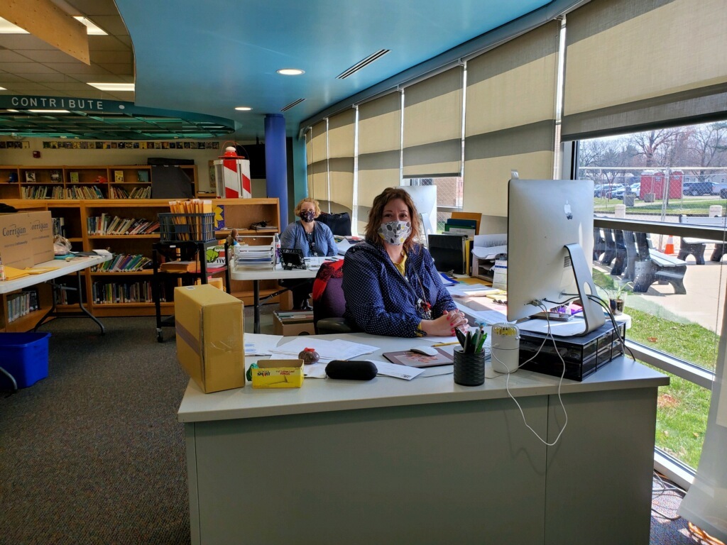 Office staff in the temporary office in the library