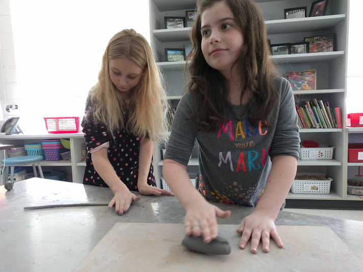Two girls making bowls