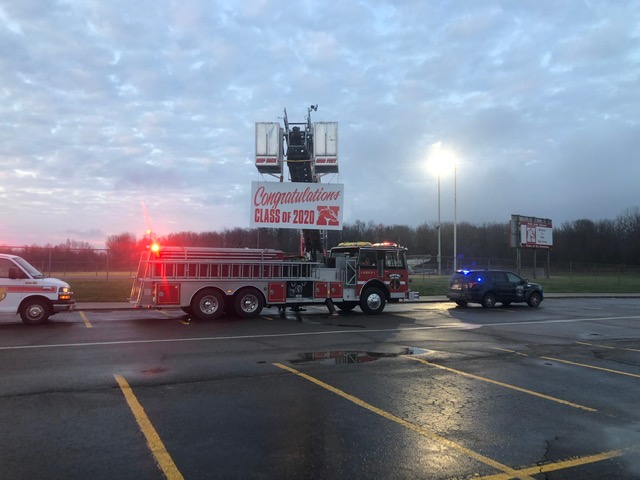 Fire truck with sign - congratulations Class of 2020, police car and ambulance with lights going
