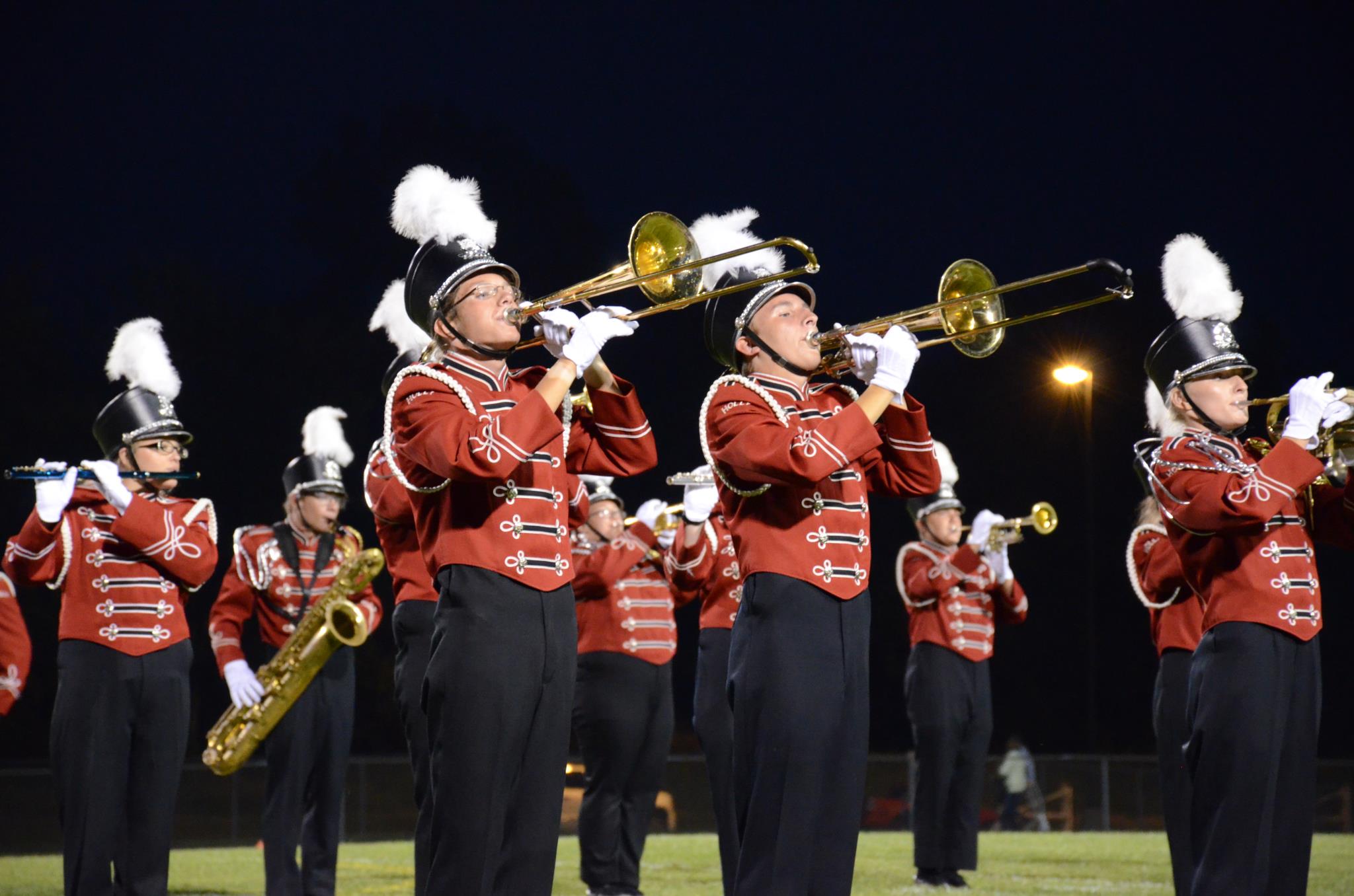 Marching band members performing on the field