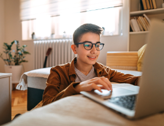 Middle school student working on a computer.