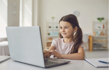 Elementary student working at a computer.