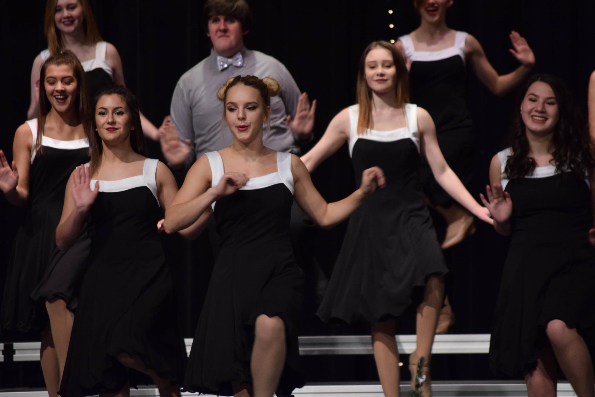 Choir members performing a routine