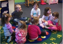 Small group of students sitting on the rug