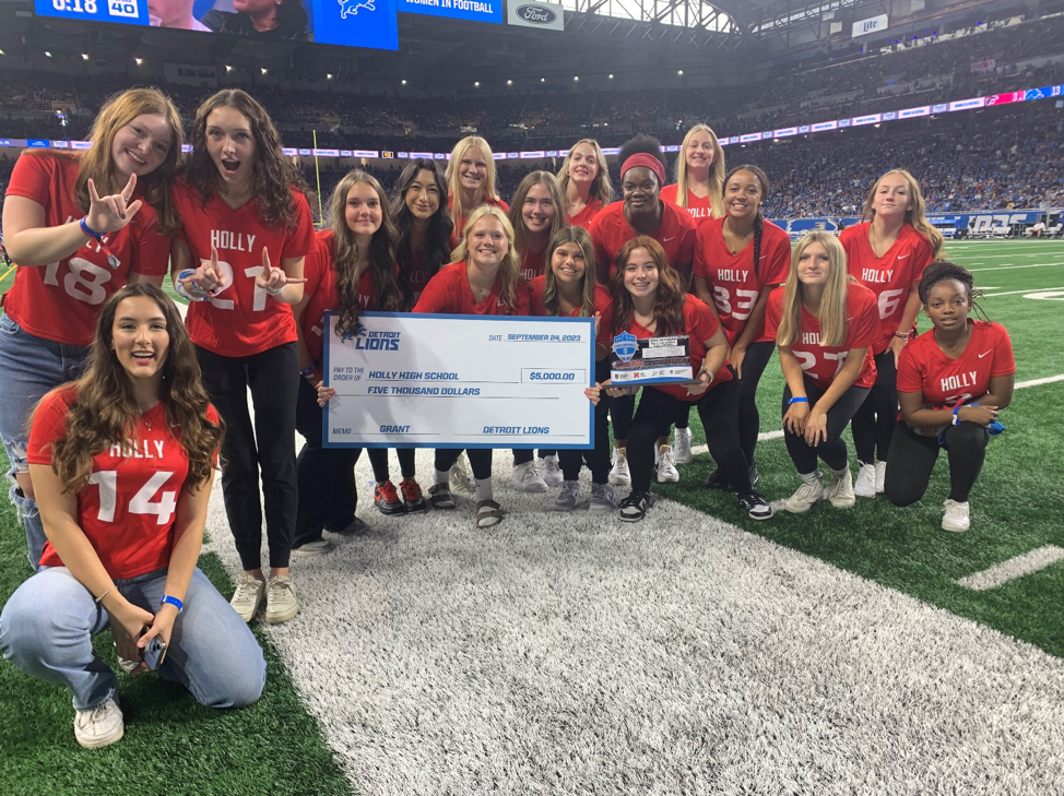 girls football team with check